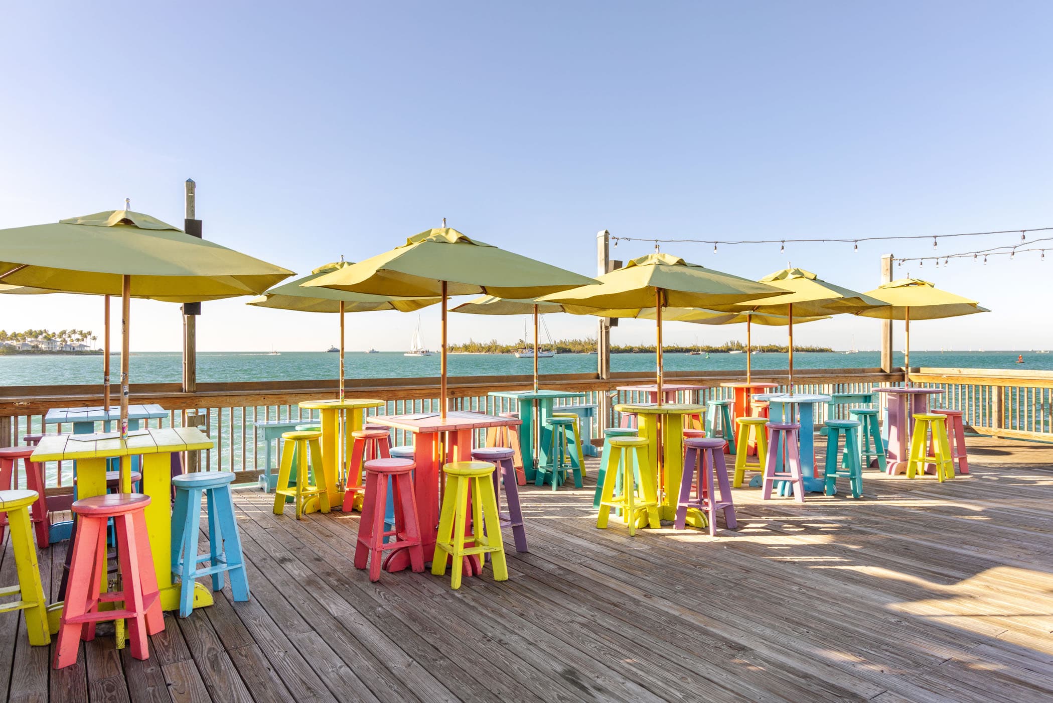 The pier full of table, stools and umbrellas