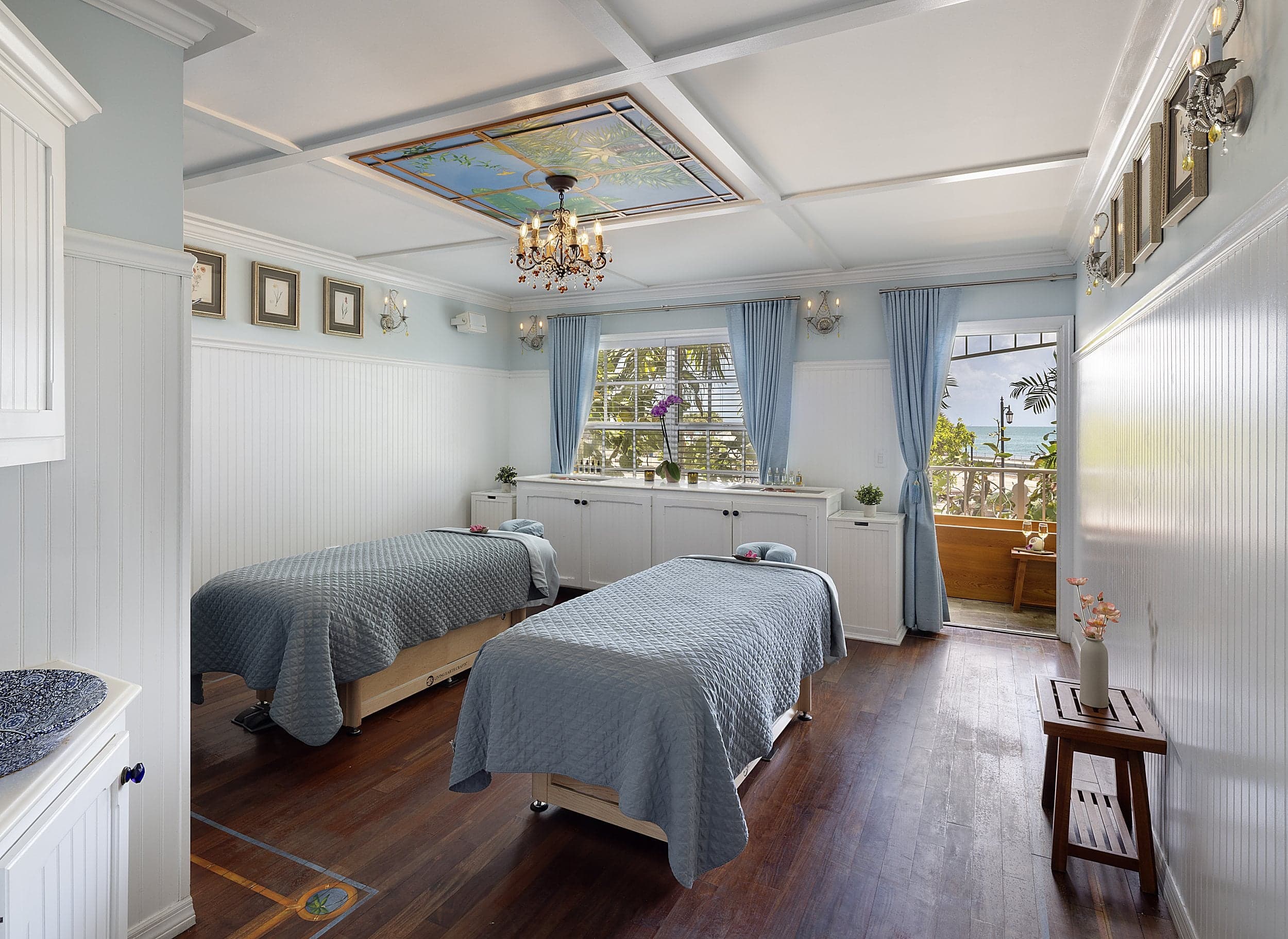 Spa treatment room with dual massage tables and ocean-view balcony at Ocean Key Resort, Key West, Florida